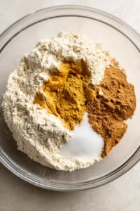 Combine all-purpose flour, pumpkin puree, pumpkin spice, and sugar in a mixing bowl.