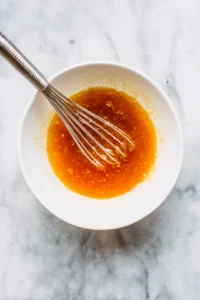 Combine apricot preserves, honey mustard, and soy sauce in a mixing bowl and mix well
