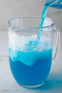 Combine blue sports drink and cold water in a large pitcher