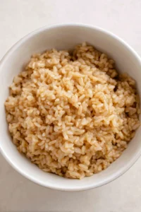 Combine cooked rice, soy sauce, and sugar in a bowl
