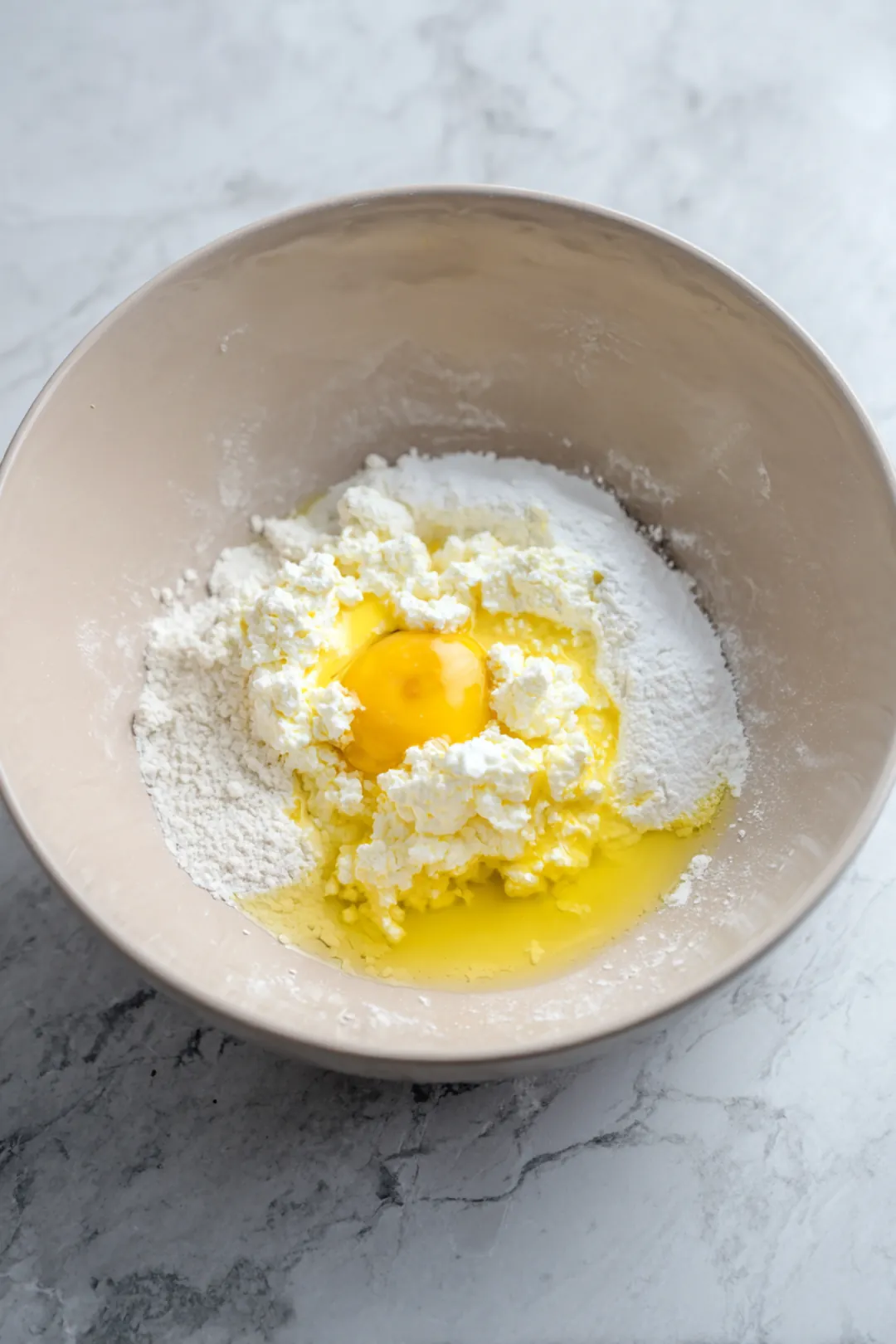 Combine cottage cheese, egg, almond flour, baking powder, salt, and olive oil in a mixing bowl