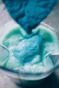Combine fresh lemonade, ice, and blue spirulina powder in a blender