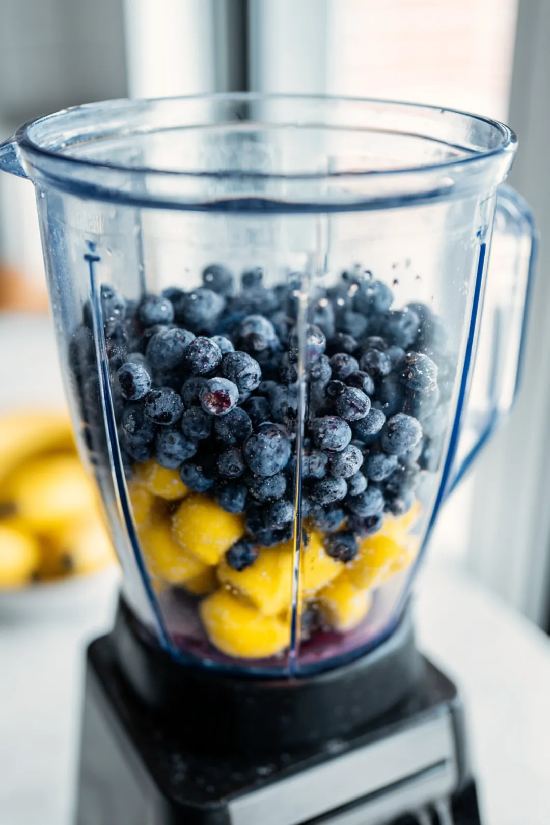 Combine frozen blueberries, fresh lemon juice, sugar, and cold water in a blender