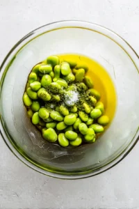 Combine frozen edamame with olive oil and sea salt