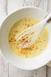 Combine heavy cream, egg yolks and grated parmesan cheese in a bowl
