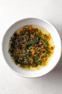 Combine lukewarm water and mixed vegetables in a bowl and soak for 10 minutes