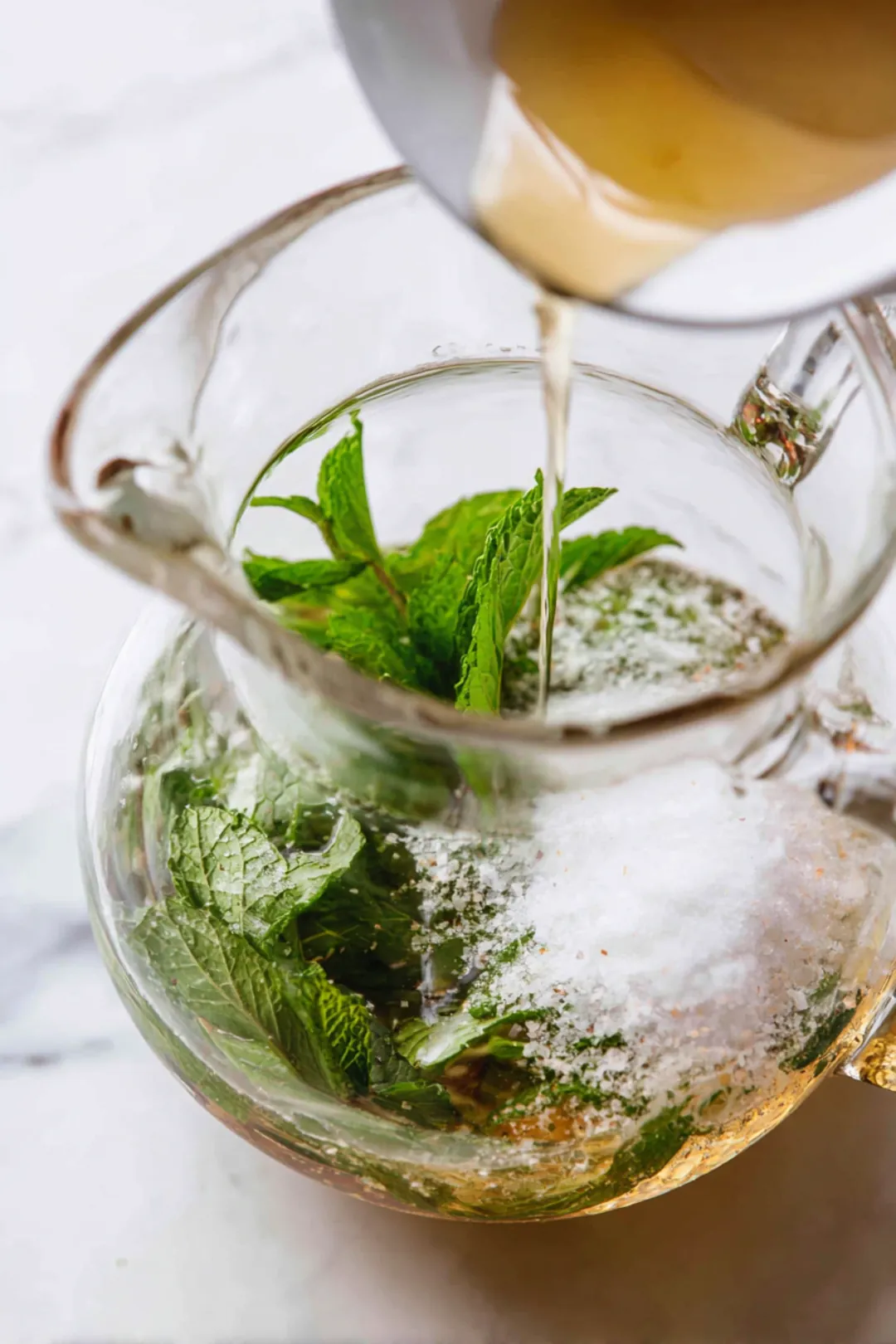 Combine lukewarm water, fresh mint leaves, sea salt, and honey in a pitcher