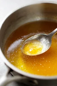 Combine lukewarm water, honey, and fruit juice in a saucepan