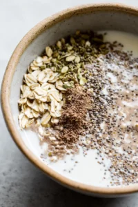 Combine rolled oats, milk, flax seeds, and chia seeds in a mixing bowl