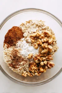 Combine rolled oats, puffed quinoa, chopped nuts, honey and coconut oil