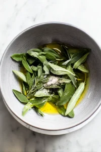 Combine sage leaves with olive oil, sea salt, and black pepper