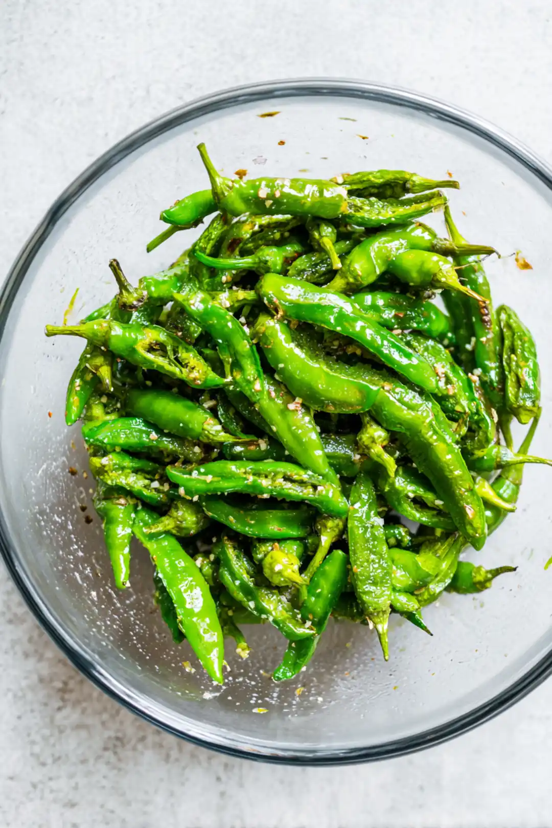 Combine shishito peppers with olive oil and sea salt