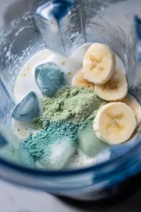 Combine the coconut milk, frozen banana, blue spirulina powder, and ice cubes in a blender and blend until smooth and creamy