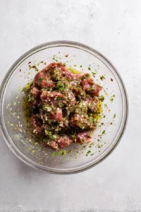 Combine the lamb with olive oil, salt, pepper, mint, and parsley