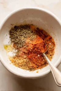 Combine the salmon skins with olive oil, sea salt, black pepper, and garlic powder until evenly coated