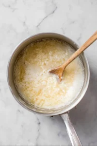 Cook Arborio rice in broth until al dente