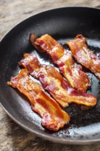 Cook bacon over medium heat until crispy