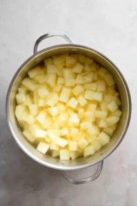 Cook diced potatoes in salted water until fork-tender