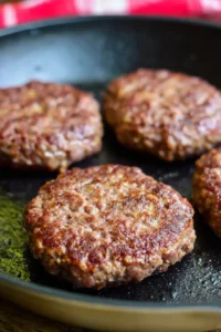 Cook ground beef patties in a skillet over medium heat until done