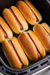 Cook hot dogs until buns are golden brown and heated through