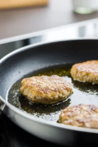 Cook patties in skillet until golden brown