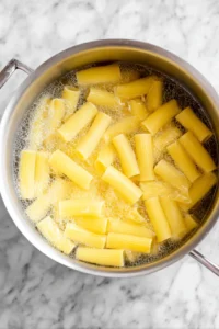 Cook rigatoni until al dente and drain