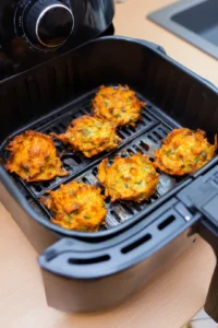 Cook the pakoras in the air fryer until golden brown and crispy