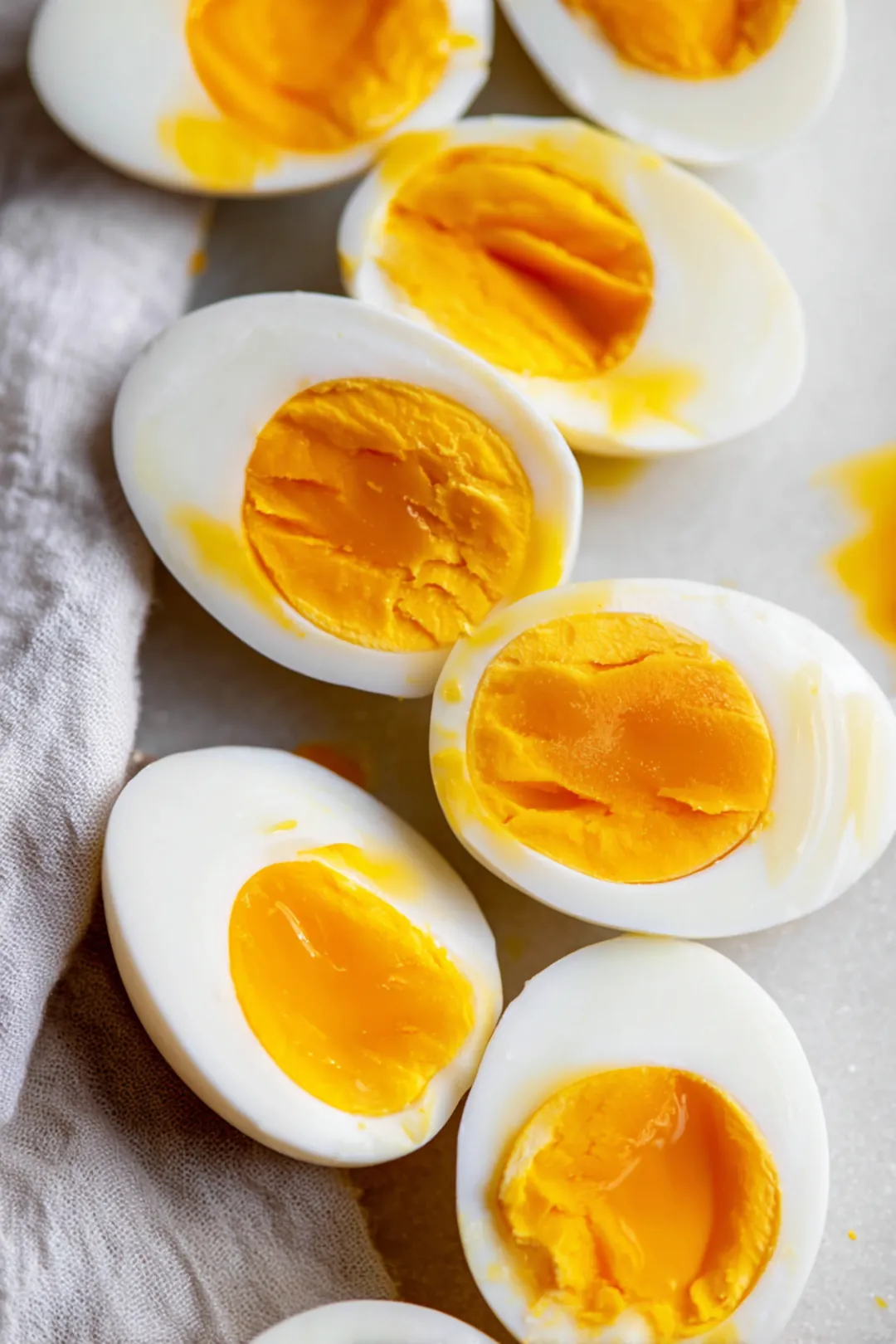 Cut the peeled eggs in half lengthwise and remove the yolks, then mix the yolks with mayonnaise, mustard, vinegar, salt, and pepper until creamy and smooth.