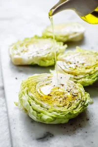 Drizzle cabbage steaks with olive oil and season with salt and pepper
