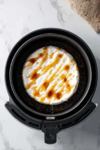 Drizzle honey over the brie cheese in the air fryer