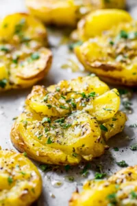 Drizzle smashed potatoes with olive oil and seasoning