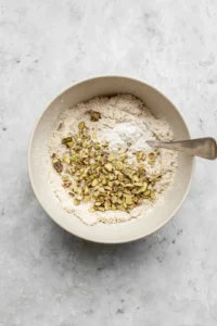 Drop spoonfuls of dough onto the prepared baking sheet and bake until golden brown