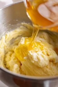 Fold in self-raising flour and add milk to achieve a smooth batter and prepare the loaf tin