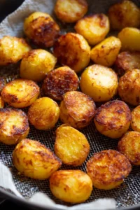 Fry potatoes in batches until golden brown and crispy
