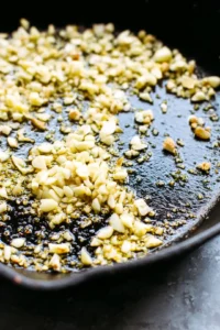 Heat olive oil in a skillet and add garlic and ginger