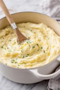Mash the potatoes with cheddar cheese and sour cream until creamy