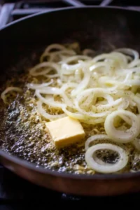 Melt butter and caramelize onions in a skillet