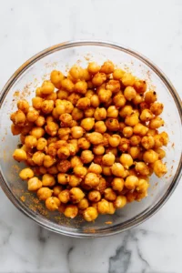Mix chickpeas with olive oil, paprika, cumin, garlic powder, salt, and black pepper