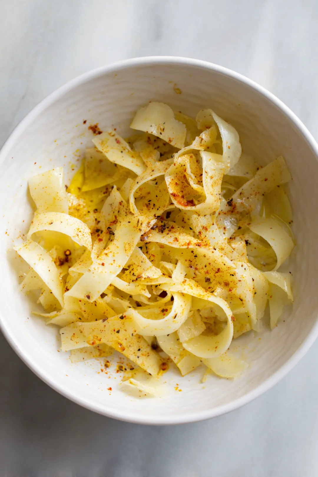Mix potato ribbons with olive oil, salt, paprika, and garlic powder