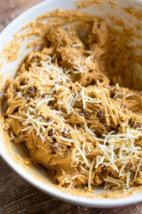 Mix refried beans and shredded cheese together in a bowl