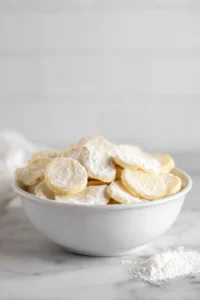 Mix sliced potatoes with cornstarch and salt until well coated