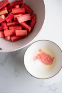 Mix sliced rhubarb with sugar, cardamom, cornstarch, and lemon juice