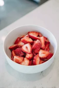 Mix sliced strawberries with sugar and let them sit