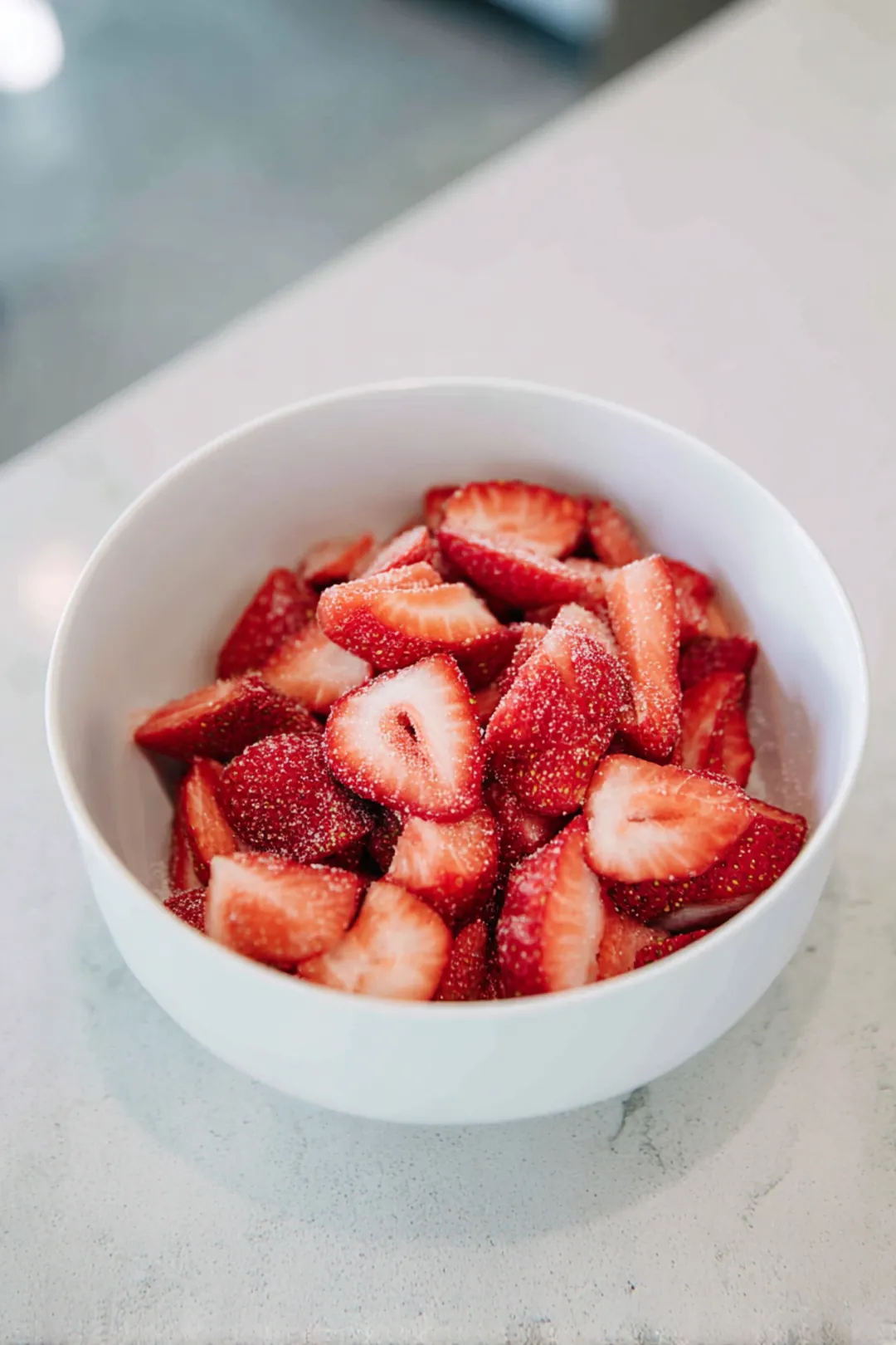 Mix sliced strawberries with sugar and let them sit