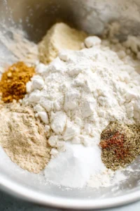 Mix together flour, water, garlic powder, onion powder, salt, and black pepper until smooth