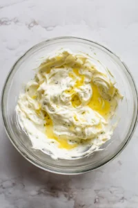 Mix together mayonnaise, pickles, and lemon juice to create tartar sauce and toast burger buns in air fryer