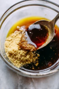 Mix together miso paste, grated ginger, soy sauce, sesame oil, and honey to create the marinade