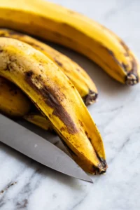 Peel and slice ripe plantains into thick pieces