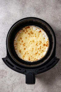 Place brie wheel in air fryer until melty and bubbly