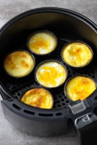 Place the ramekins in the air fryer basket and cook for 5 minutes until the eggs are set